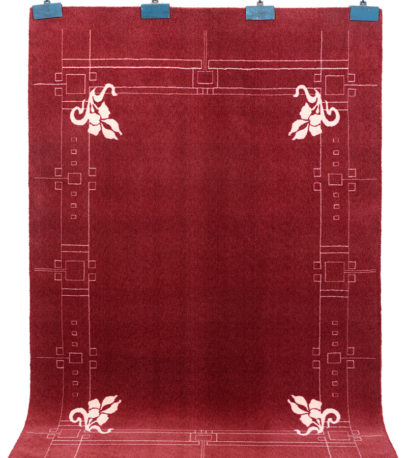 Skilled artisan carefully hand-knotting a traditional Indian rug by hand